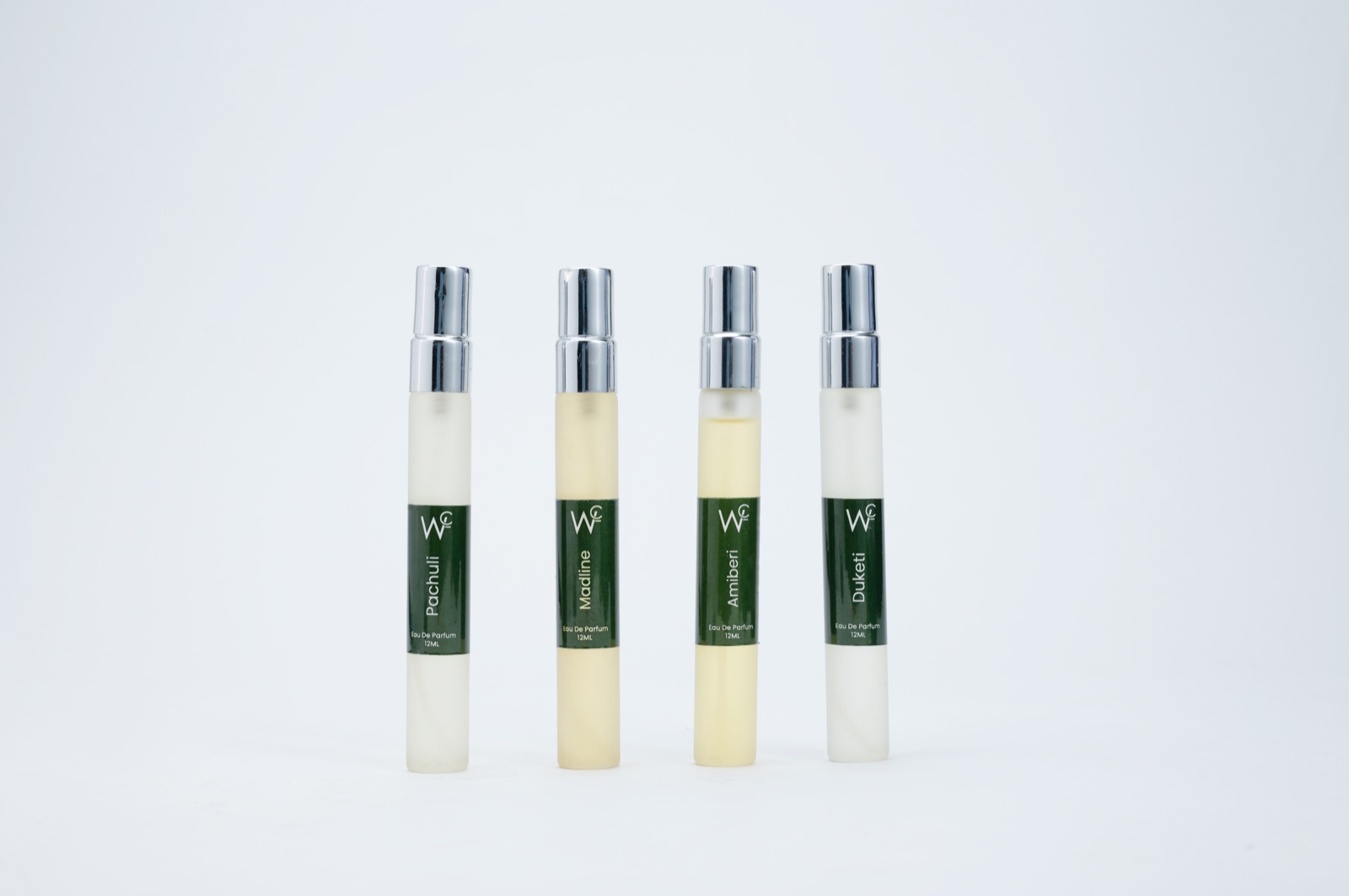 Four perfume roll-on bottles photographed on a clean white background for an Amazon product listing