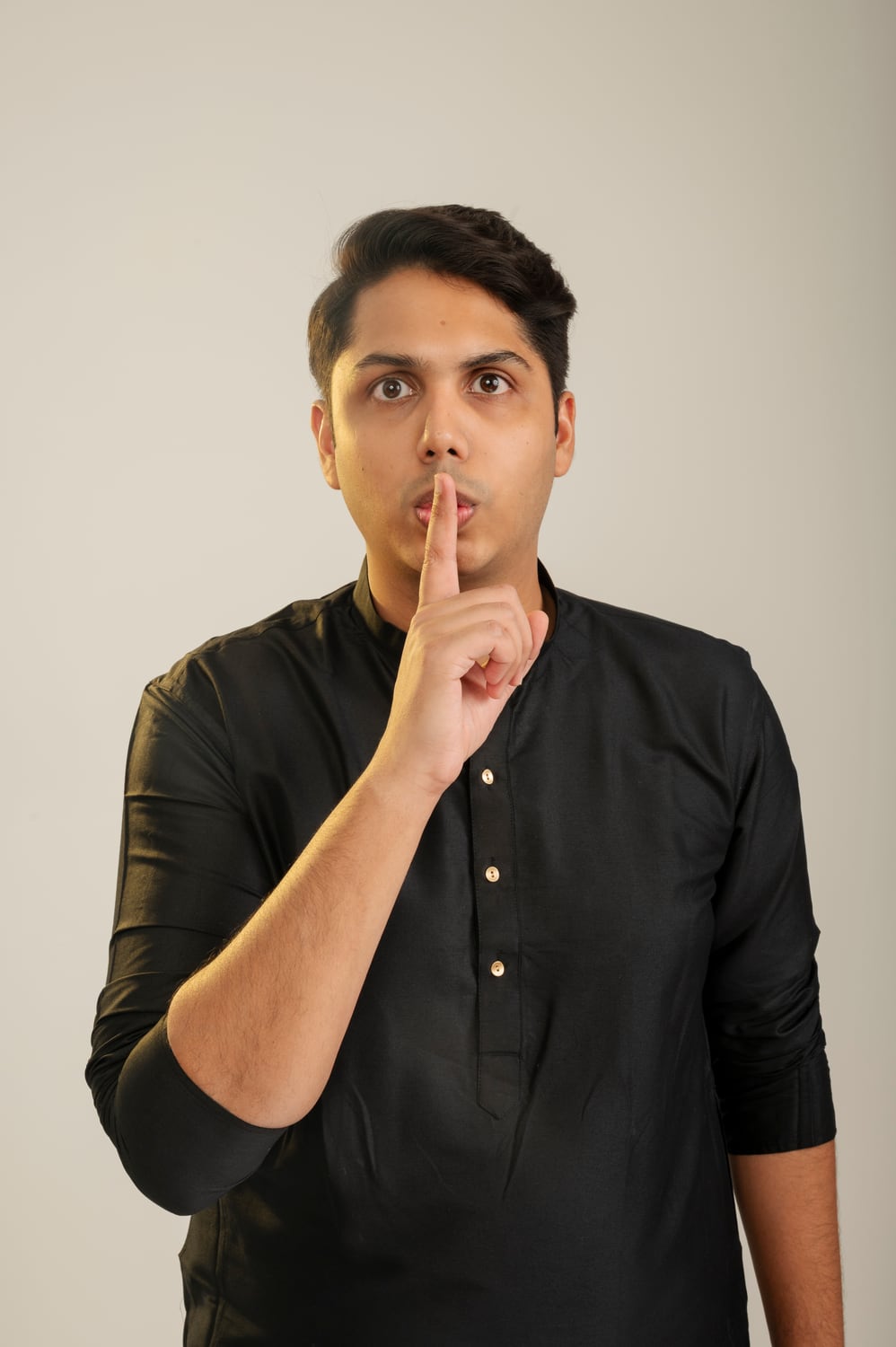 Expressive studio portrait of Nikunj Gupta in a black kurta