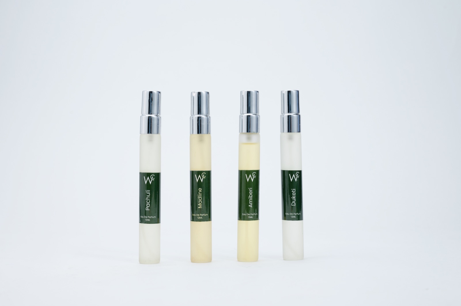 Four perfume products photographed consistently on a clean background for an e-commerce catalogue