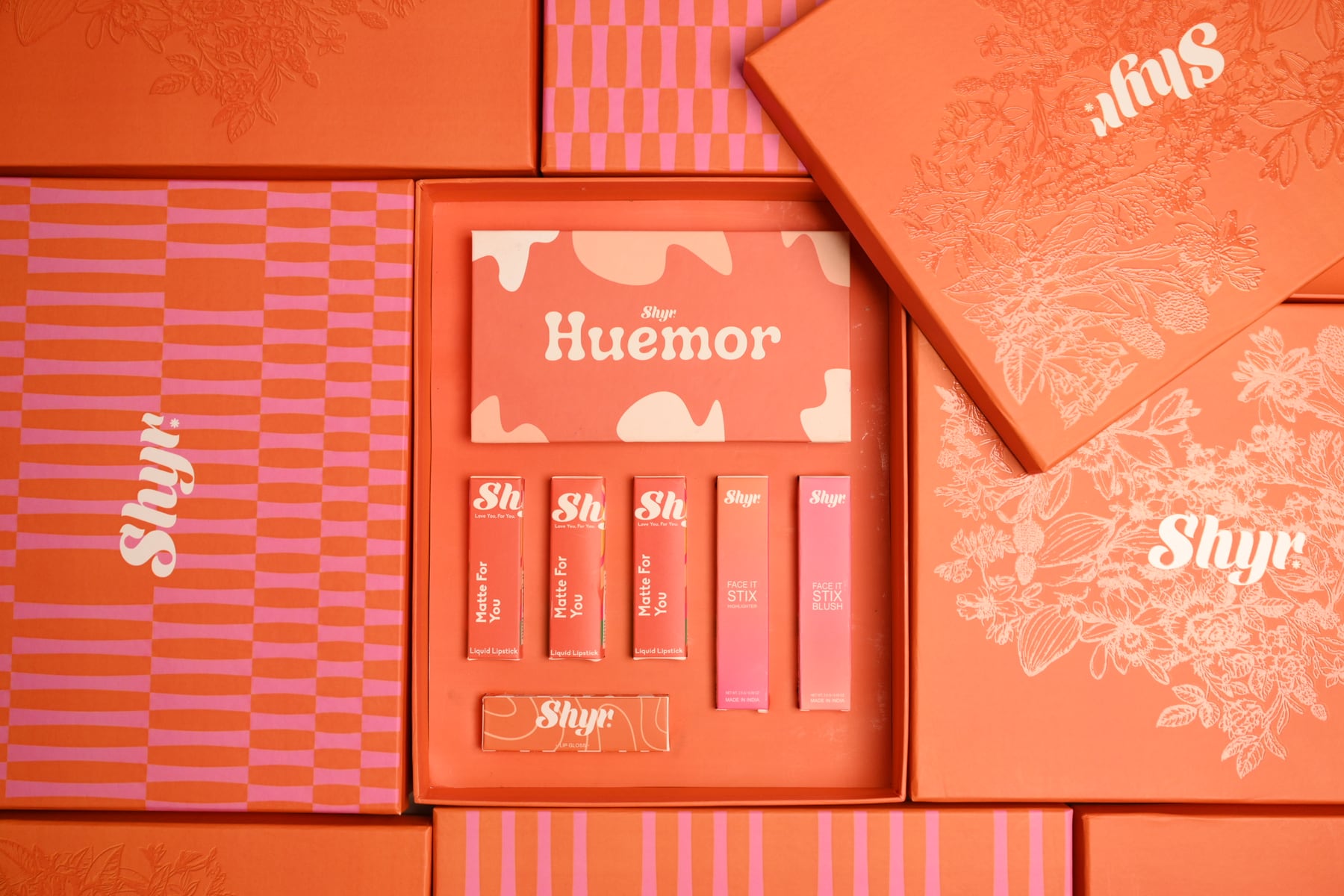 Styled orange Rakhi gift box and product collection