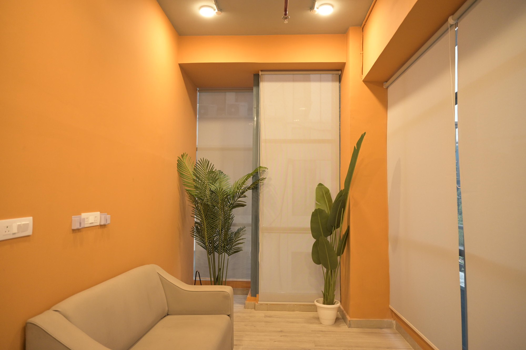 Orange lounge corner with sofa and plants