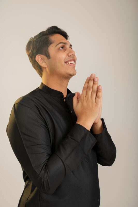 Finished professional side-profile studio portrait of a man in a black kurta at Sooper Studios in Noida