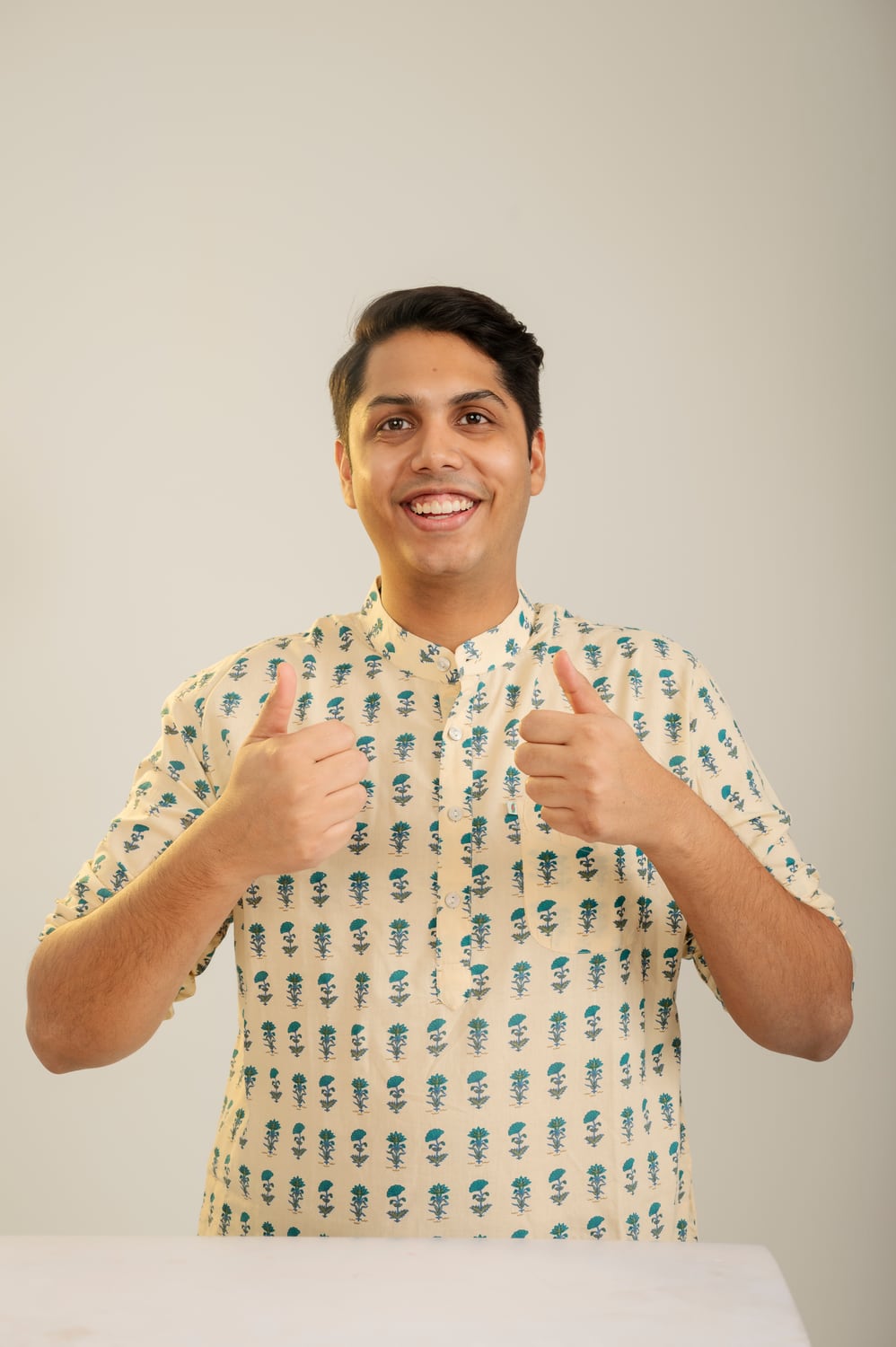 Friendly colour studio portrait of Nikunj Gupta in a patterned shirt