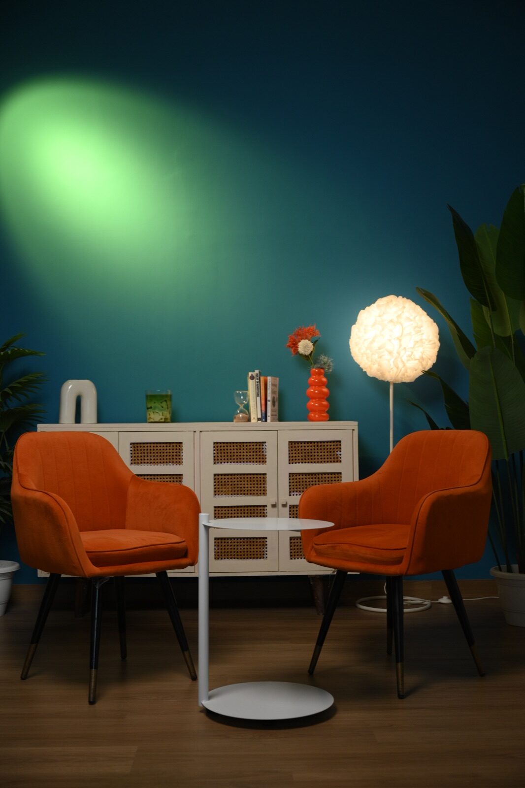 Empty two-chair podcast and interview set with coloured wall lighting at Sooper Studios