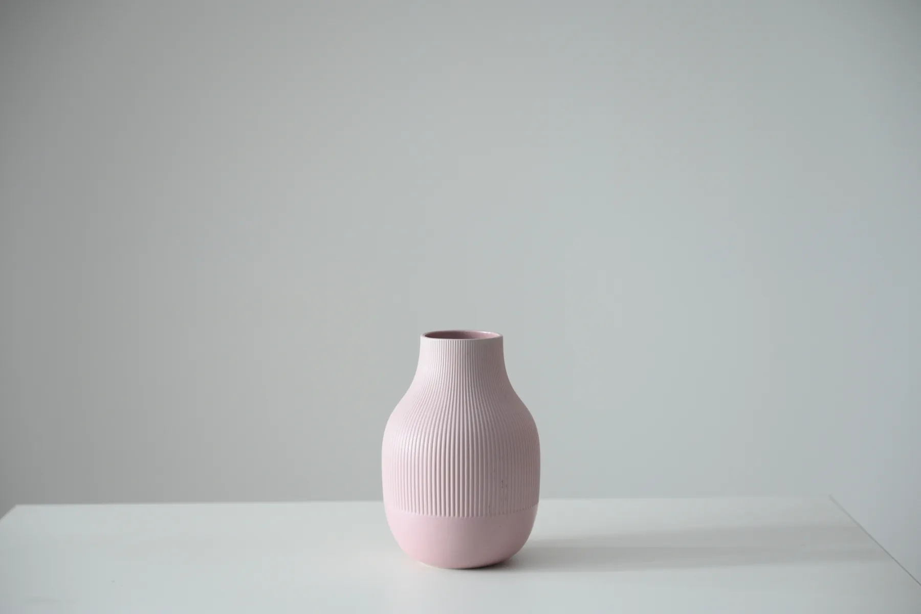 Blush pink ribbed ceramic vase available as a studio prop